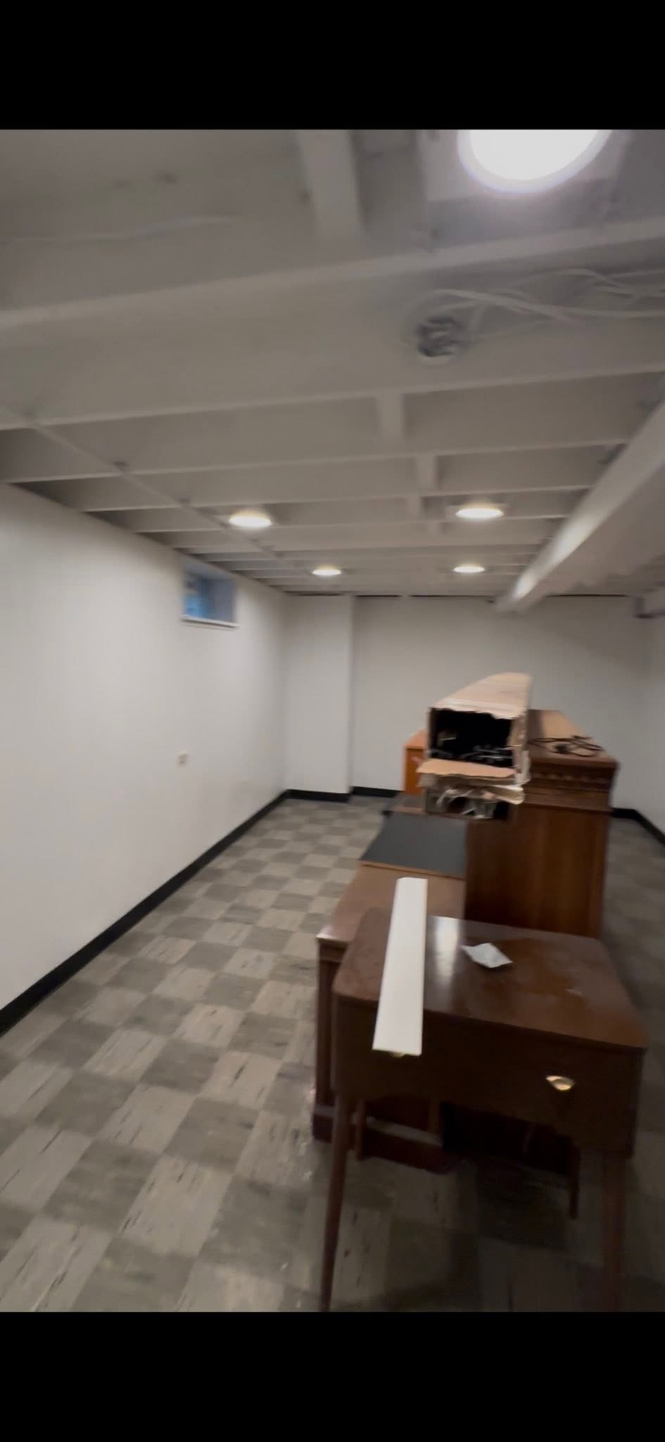 Finished basement family room with recessed lighting