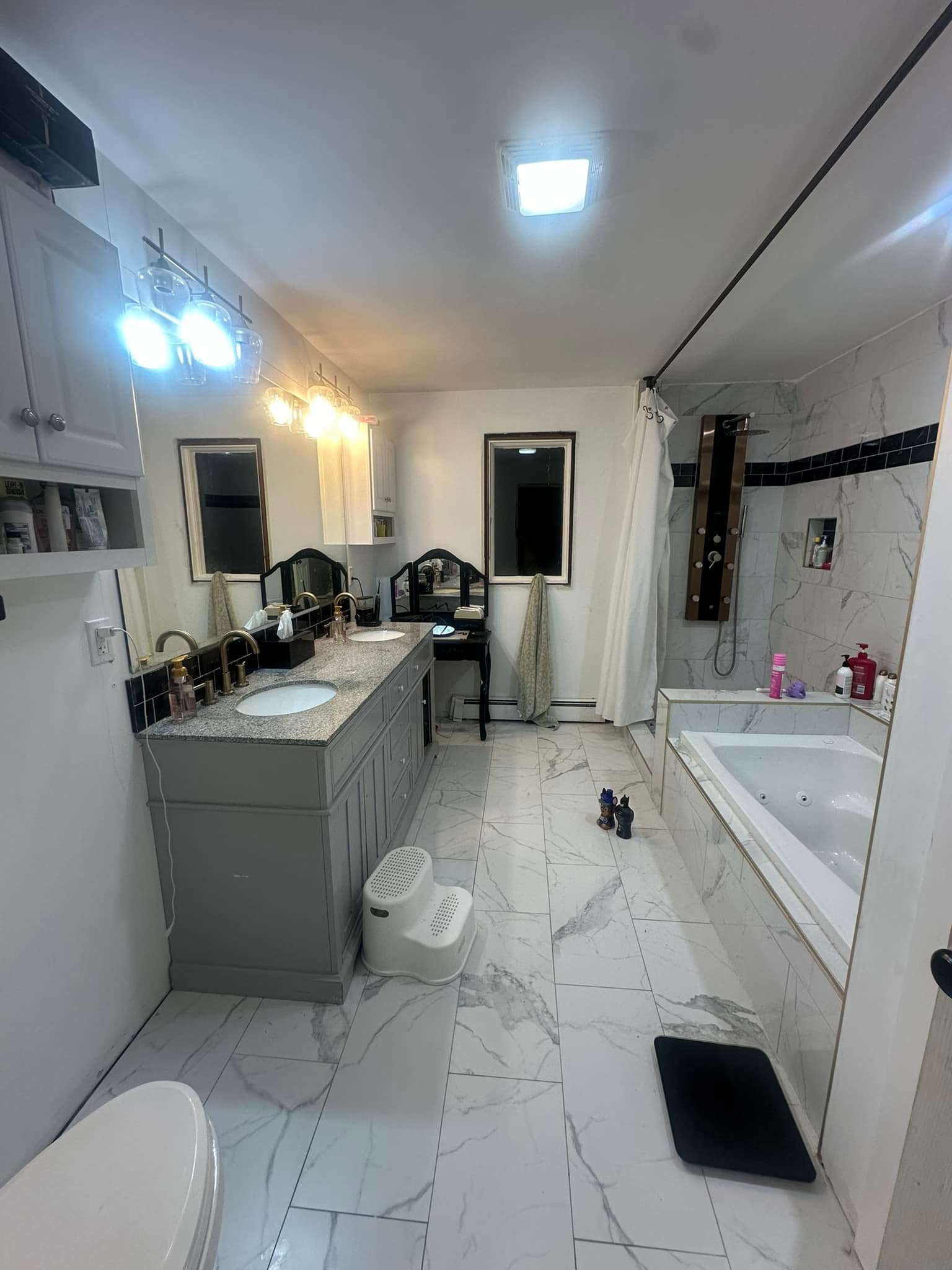 Marble bathroom remodel with double vanity, soaking tub and rain shower