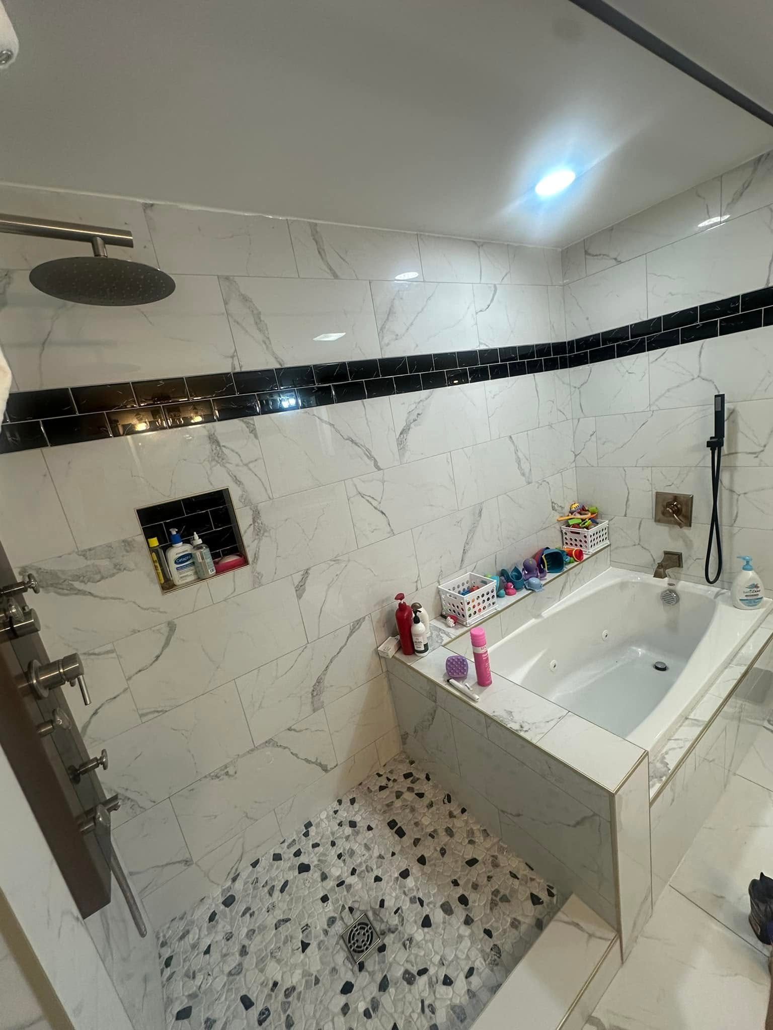 Marble-tile bathroom remodel with soaking tub and rain shower