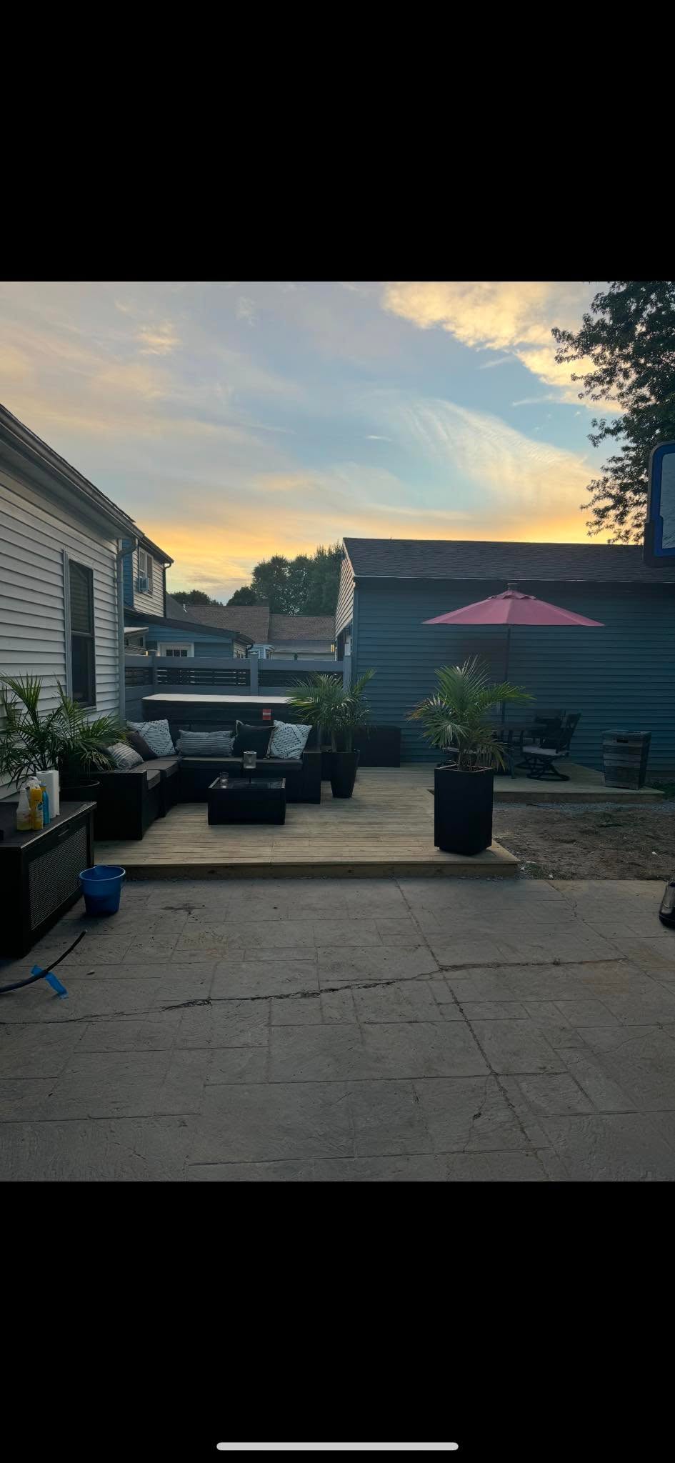 Finished deck and stamped-concrete patio with outdoor seating