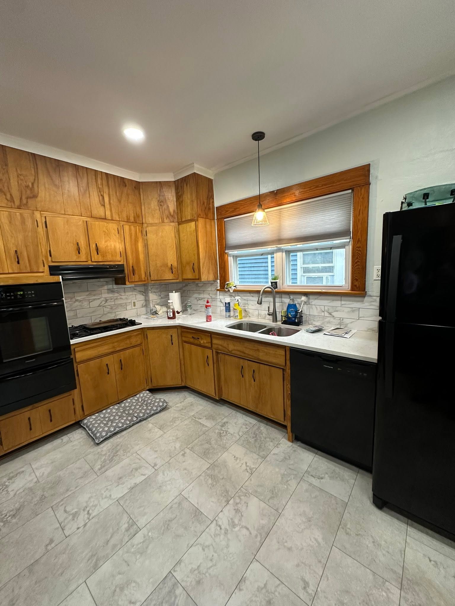 Finished kitchen with oak cabinets and tile floor