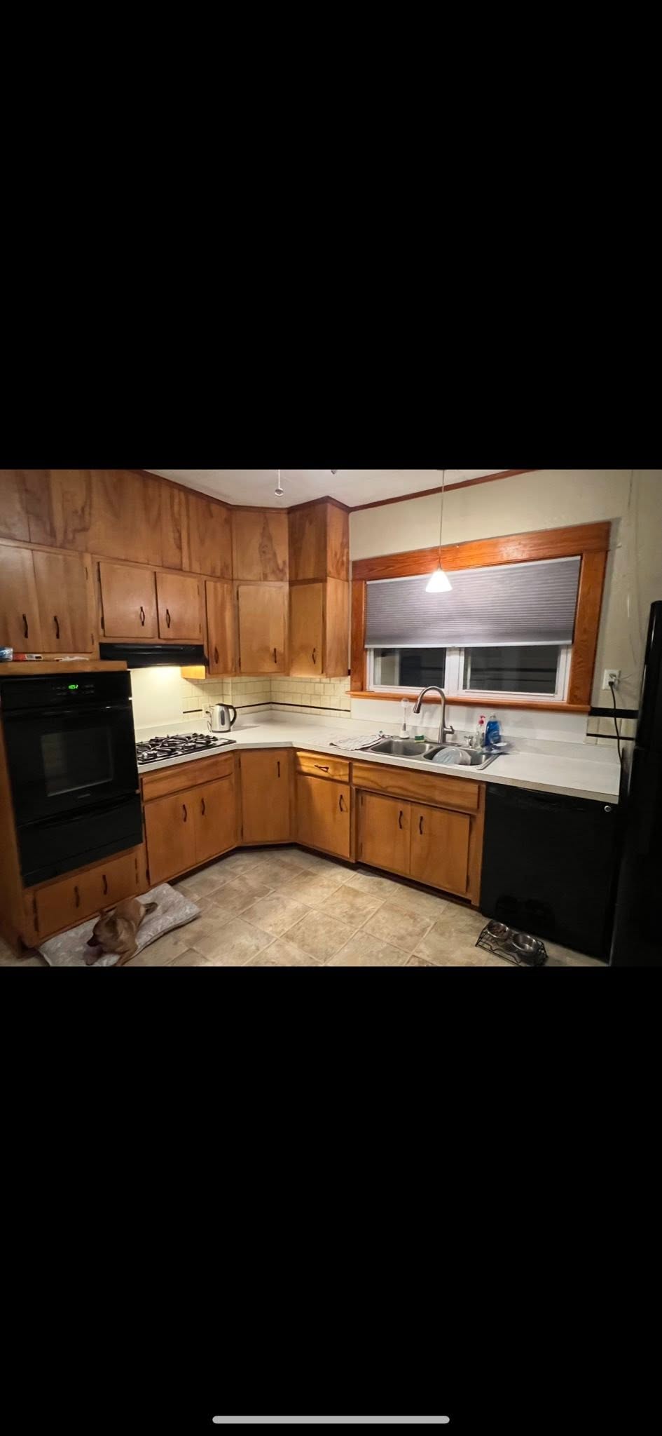 Finished kitchen with oak cabinets and tile floor