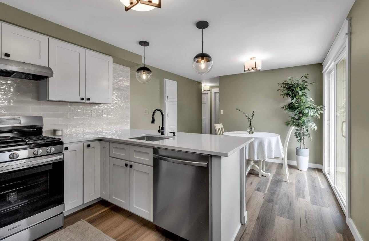 Kitchen remodel with peninsula counter, quartz top and pendant lighting